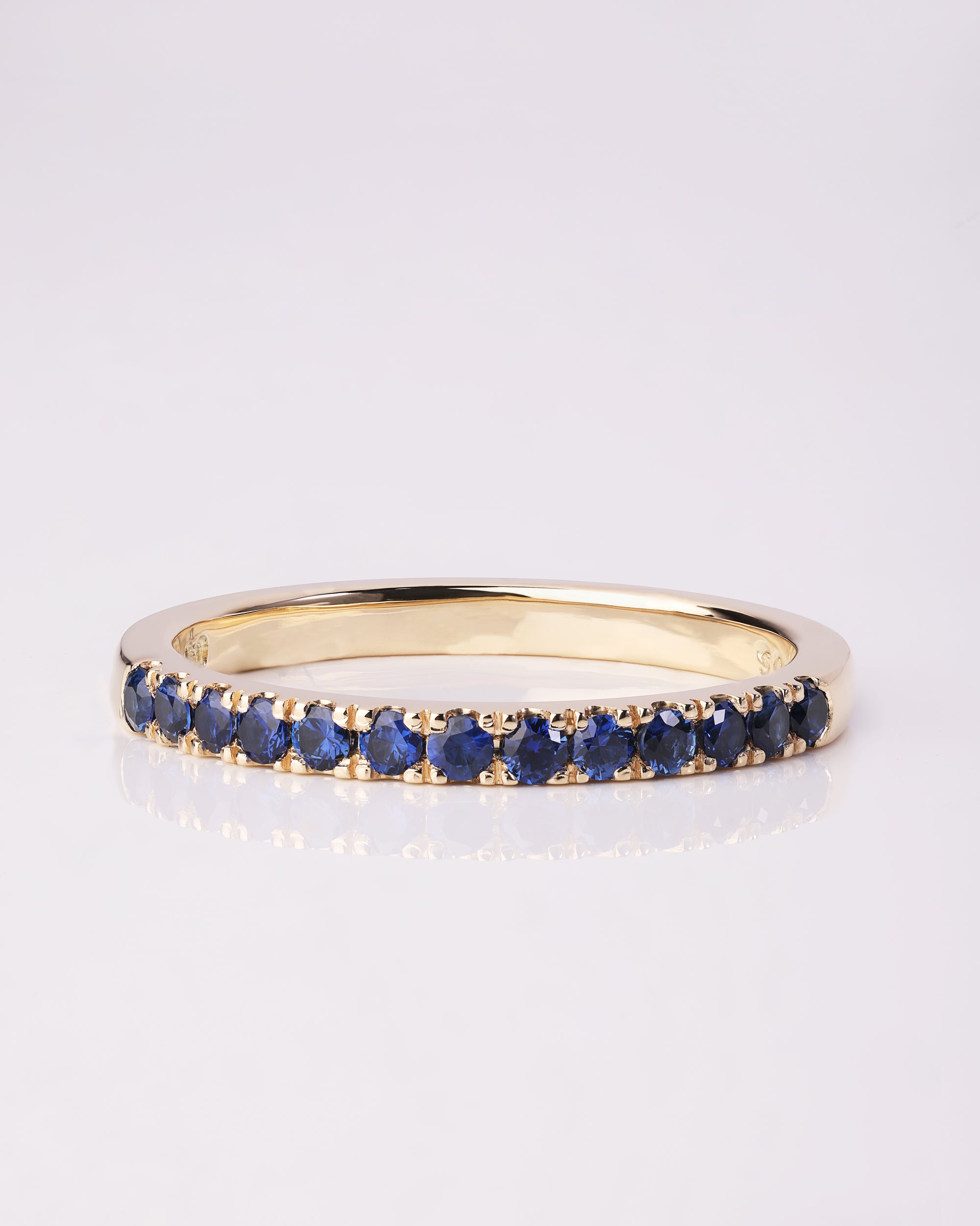 Handcrafted 18ct Yellow Gold band half set with Round Brilliant Cut Blue Sapphires.